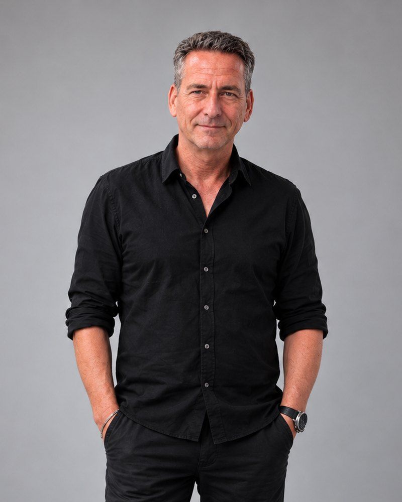 Andreas Kesler in schwarzem Hemd vor grauem Hintergrund